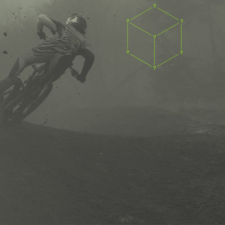 Background of an MTB Rider and a minimalistic Mystery Box with question marks on its corners.